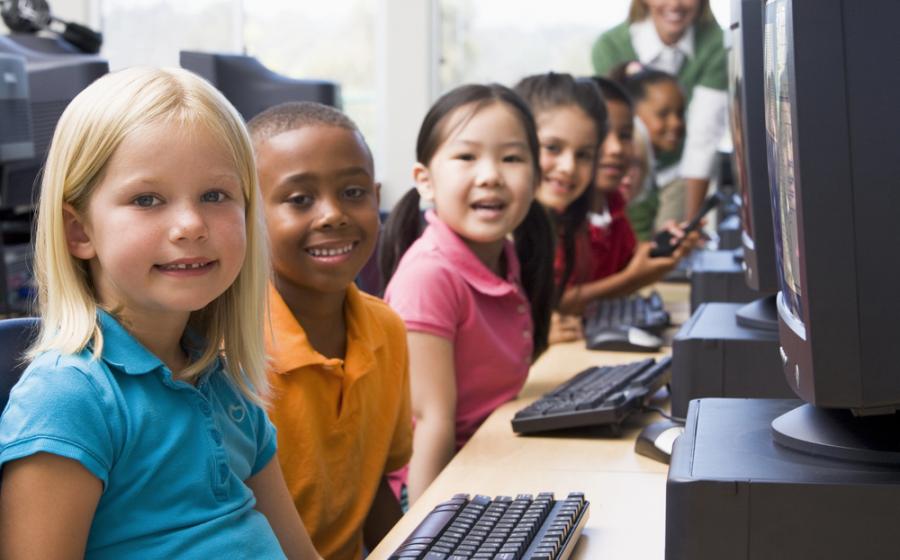 Kindergarten children learning how to use computers.
