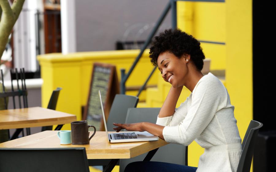 Happy woman using laptop
