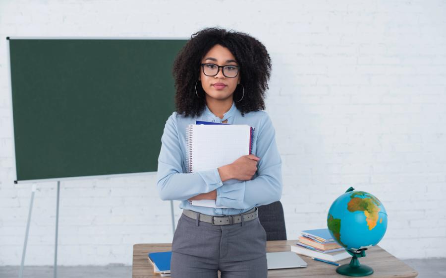 teacher holding a laptop