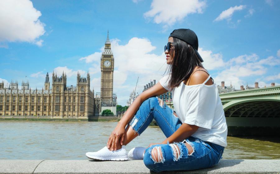 Asian woman at waterfront by the river Thames at the famous Westminster on a city trip in London