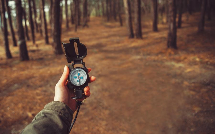 Woman searching direction with compass