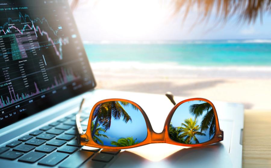 remote work in a tropical sea beach. Laptop, sunglasses, waves