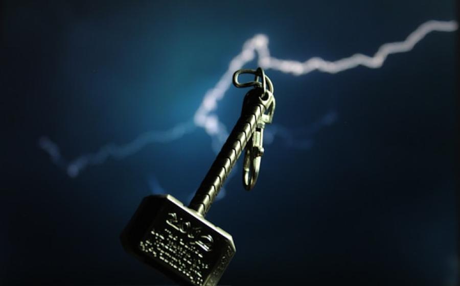 Thor's hammer, with lightning against a dark background