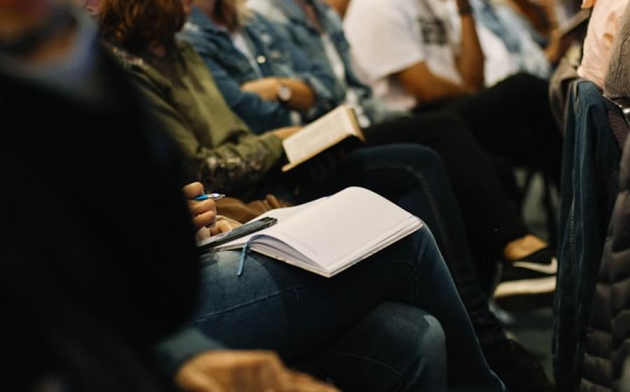 Partial photo of students listening to a lecture