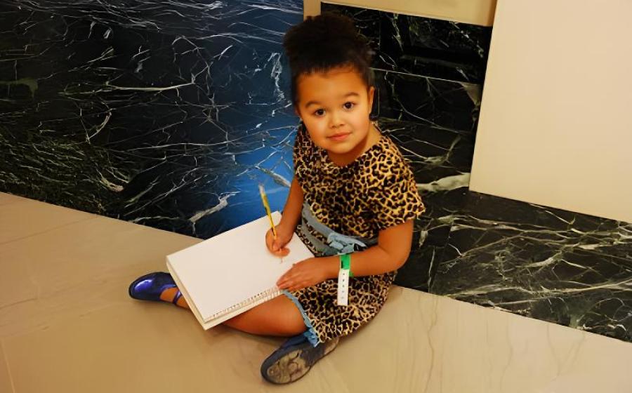 Small girl drawing at an art museum