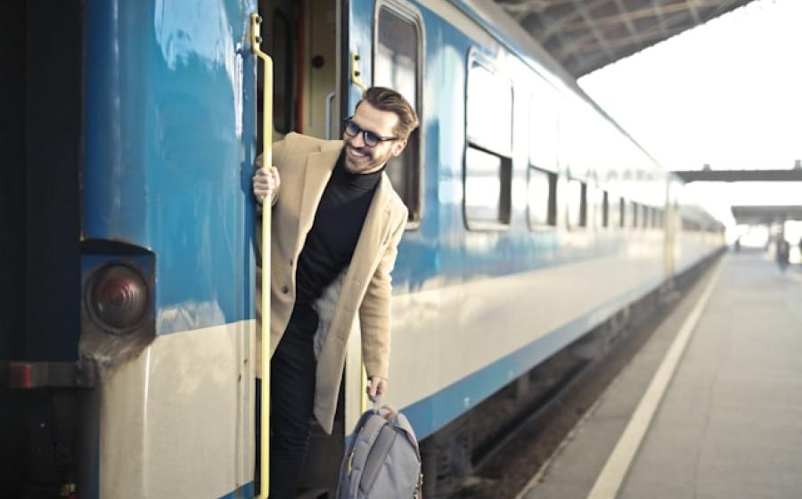 Man looking out of a train doorway