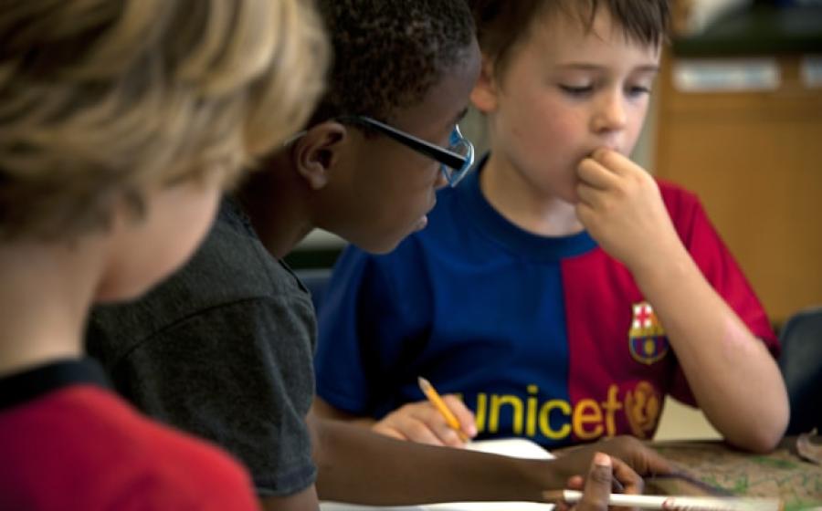 Team of kids working together in the classroom
