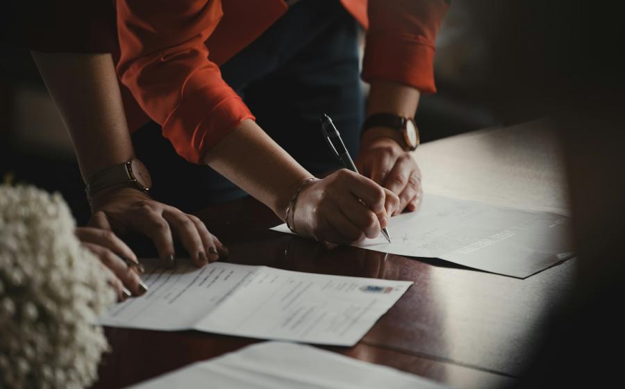 Two people filling out paperwork