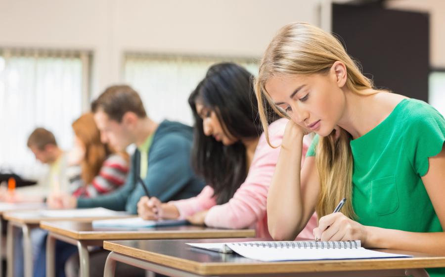 students writing in a classroom