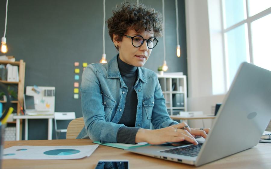 teacher writing on a laptop