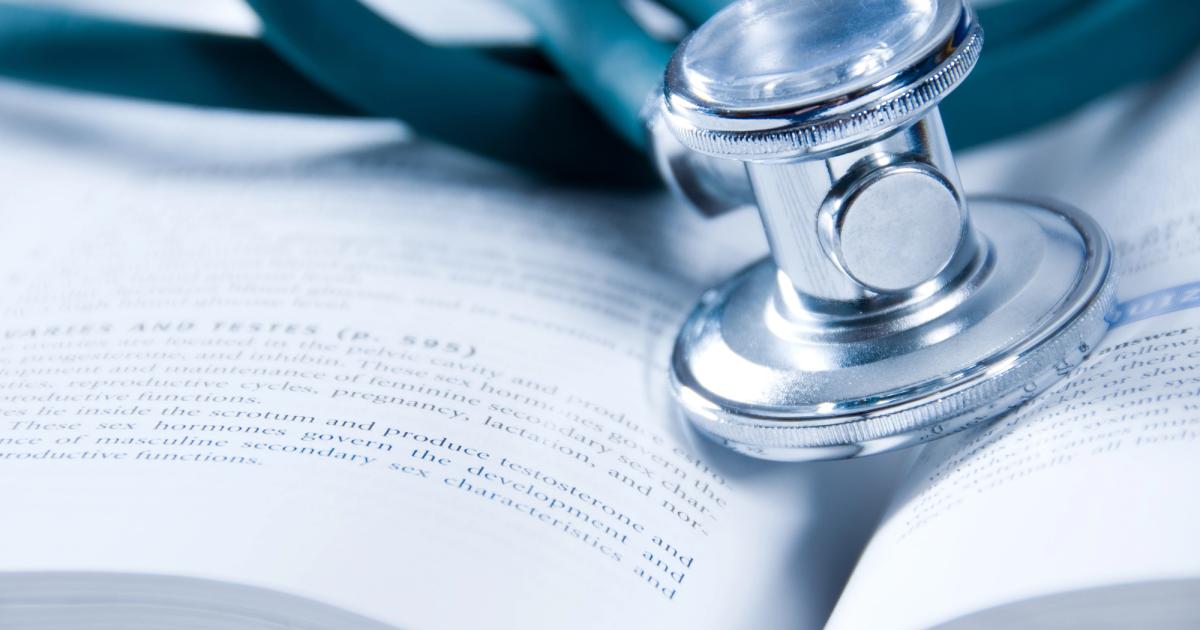 medical school book and stethescope