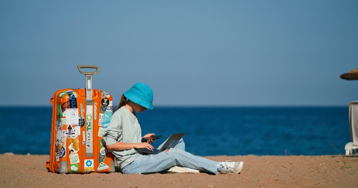 traveler with suitcase on beach